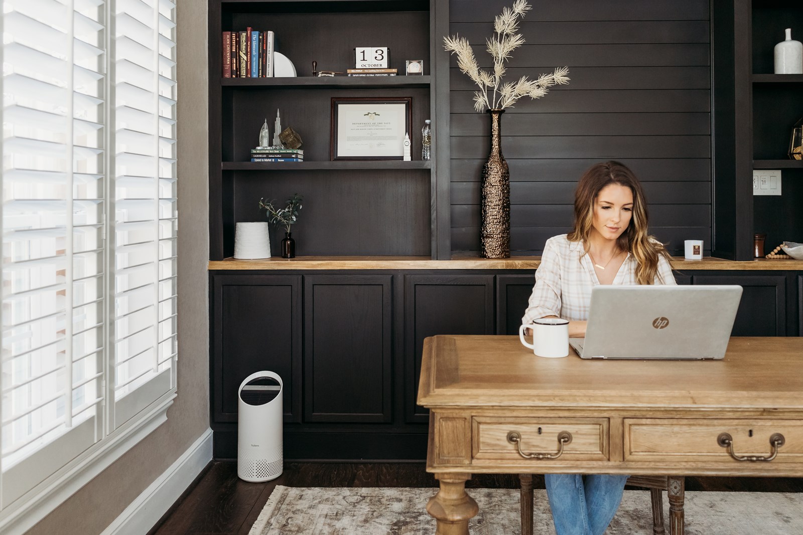 Woman working on a laptop in her office. 